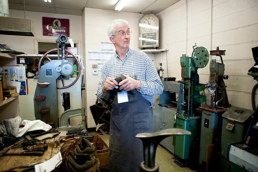 	<p>John&#8217;s Shoe Repair owner and <span class="caps">MSU</span> alumnus Tim Herwaldt looks away as he repairs a shoe at his shop Wednesday, March 28, 2013, at 415 N. Clippert St. in Lansing. </p>
