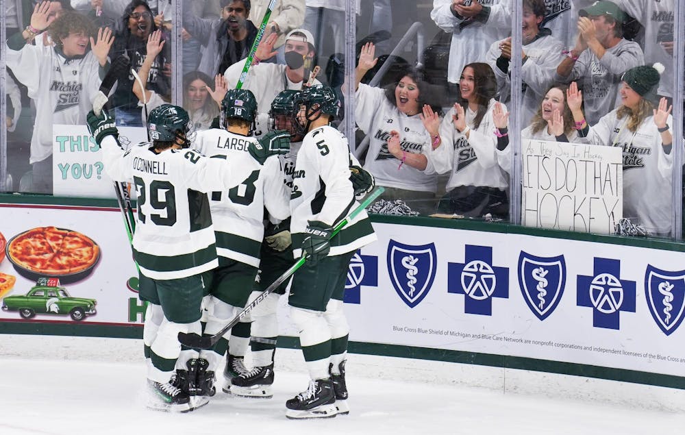 <p>MSU celebrates forward Red Savage's first goal as a Spartan at Munn Ice Arena on Saturday, Oct. 7, 2023. The Spartans won 5-2. Savage was drafted by the Detroit Red Wings in the fourth round in 2021 and wears the number 21.</p>