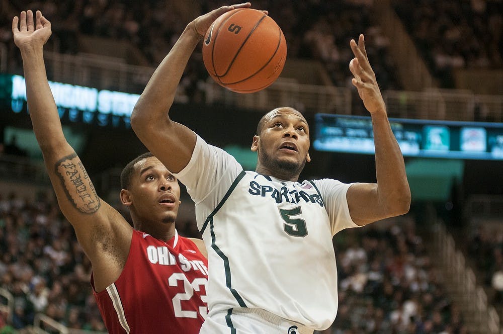 <p>Then-senior center Adreian Payne goes up for a point while defended by then-Ohio State center Amir Williams on Jan. 7, 2014, at Breslin Center. The Spartans defeated the Buckeyes in overtime, 72-68. Danyelle Morrow/The State News</p>