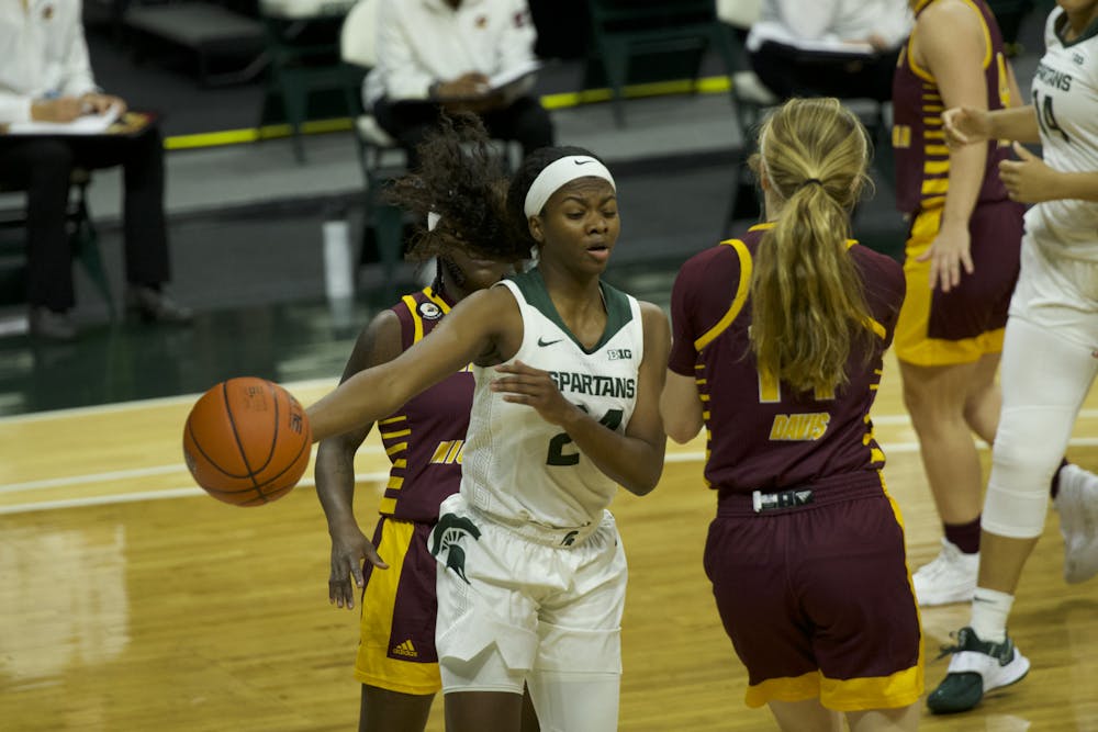 <p>Nia Clouden drives and passes the ball against Central Michigan in the Spartans&#x27; 79-70 win on Dec. 18, 2020, at the Breslin Center.</p>