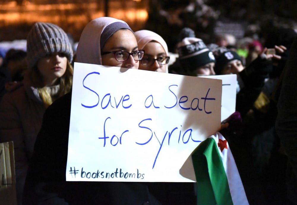 Physiology senior Tasneem Sannah holds up her poster on Jan. 31, 2017 at The Rock. The Michigan State Muslim Students' Association hosted a "No Ban, No Wall: Spartans for Sanctuary and Solidarity" as a response to President Trump's executive order on Muslim immigrants and refugees.