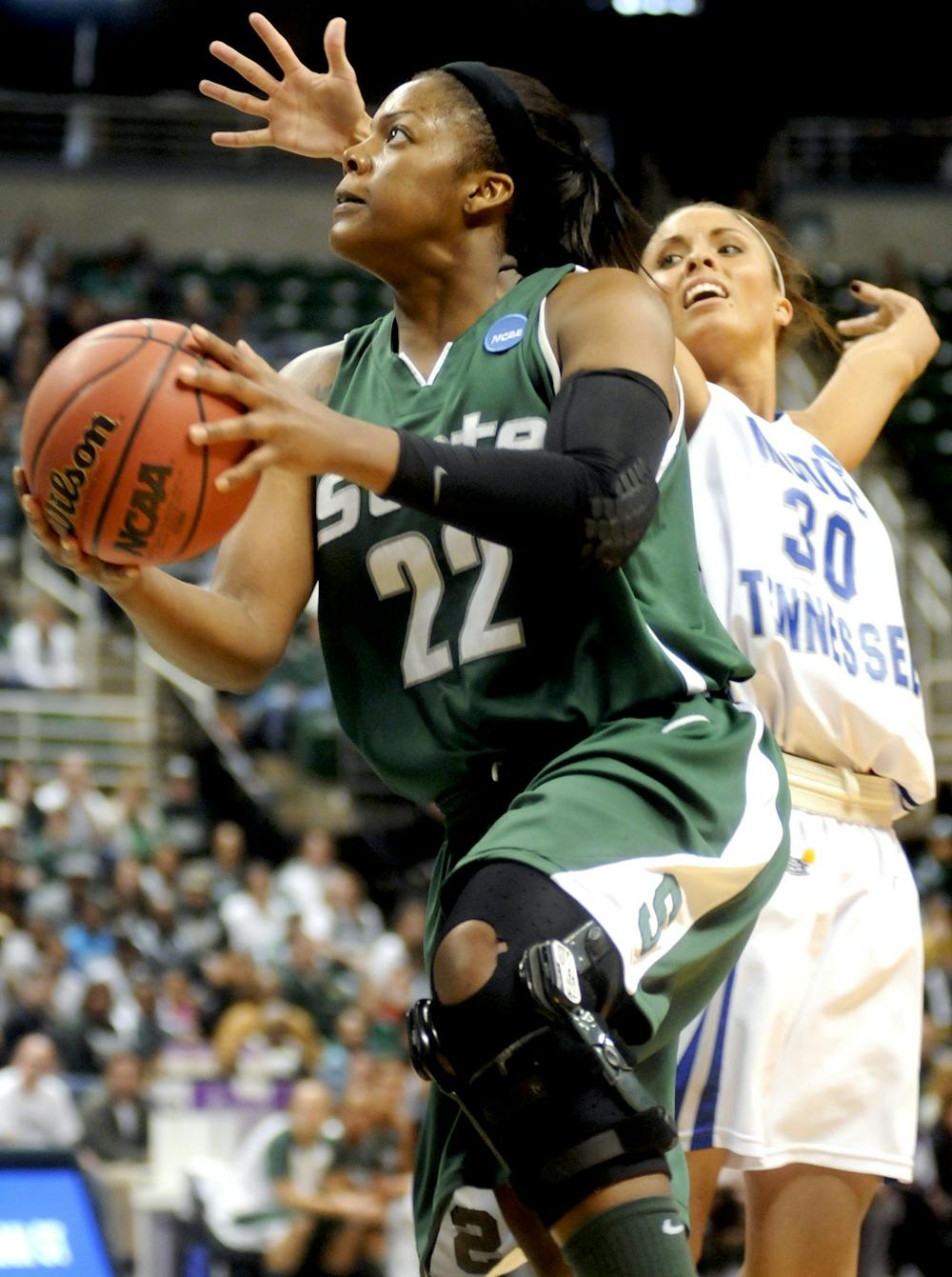 Aisha Jefferson, a junior forward, flies by Middle Tennessee State University's Anne Marie Lanning for the layup during the first half of Sunday's NCAA first round match up between the No. 9 Spartans and No. 8 Middle Tennessee State University at Breslin Center. Jefferson helped the Spartans to a 60-59 win with 10 rebounds, 20 points and one assist. They will advance to the next round of the tourney, playing the winner of the Duke, Austin Peay game Tuesday at Breslin Center. Katie Rausch/The State News 