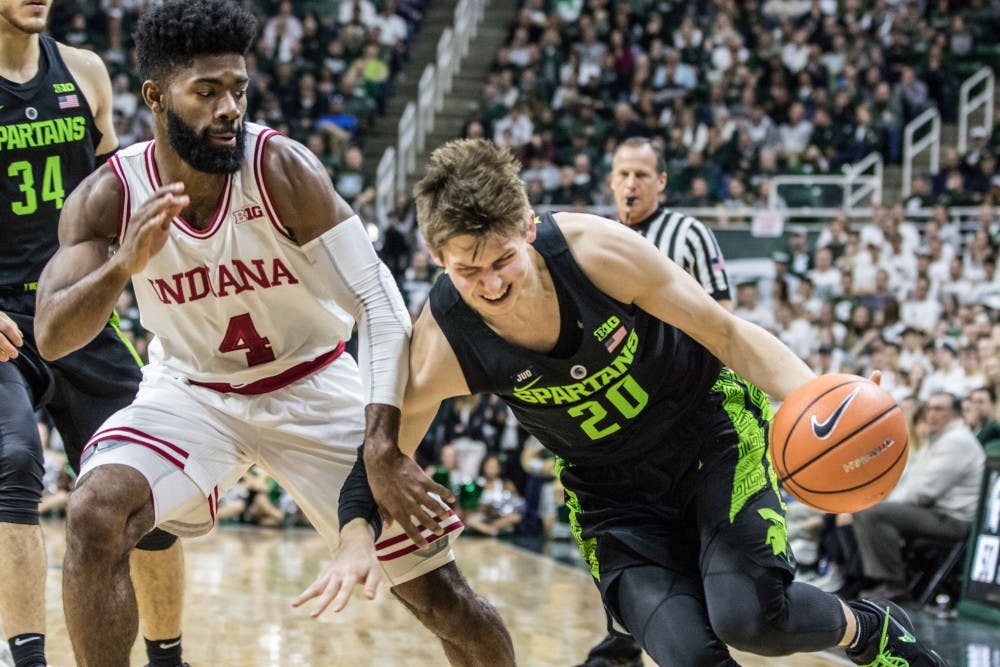 Junior guard Matt McQuaid (20) drives on the baseline during the game against Indiana on Jan. 19, 2018, at the Breslin Center. The Spartans defeated the Hoosiers, 85-57.