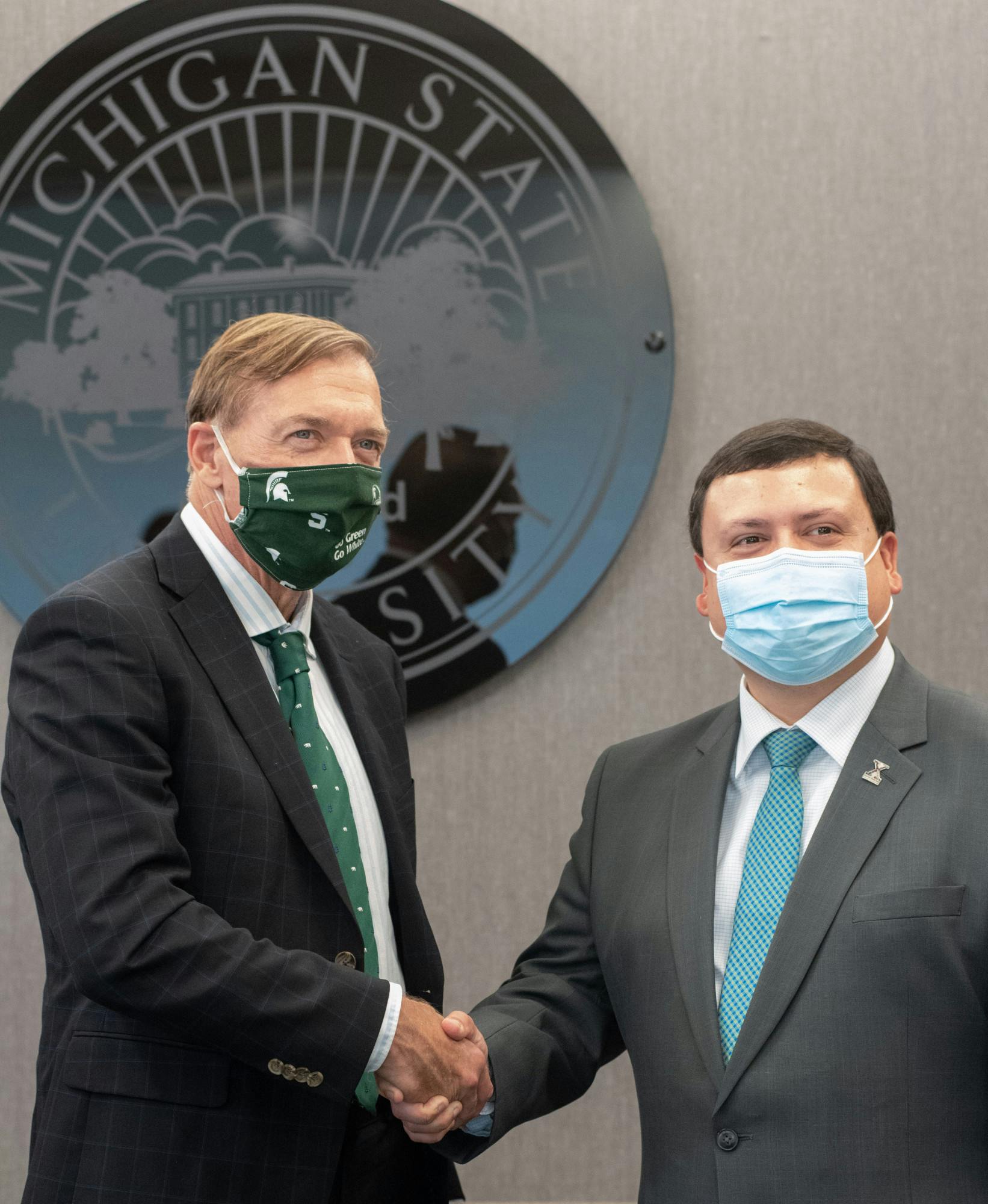 <p>Michigan State&#x27;s President Samuel L. Stanley shakes hands with Xavier DeGroat, founder of the Xavier DeGroat Autism Awareness Foundation, photographed on Sept. 29, 2021.</p>