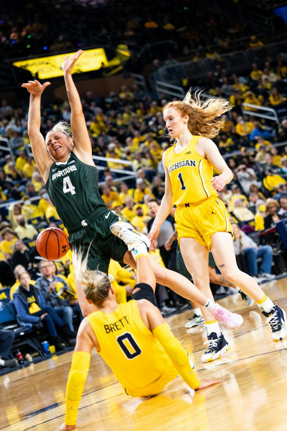<p>Michigan State sophomore guard No. 4 Theryn Hallock falls after a shot attempt at the Crisler center in Ann Arbor on Feb. 18, 2024. Michigan State secured a season sweep of the rival Wolverines, breaking a two-game losing streak in the process.</p>