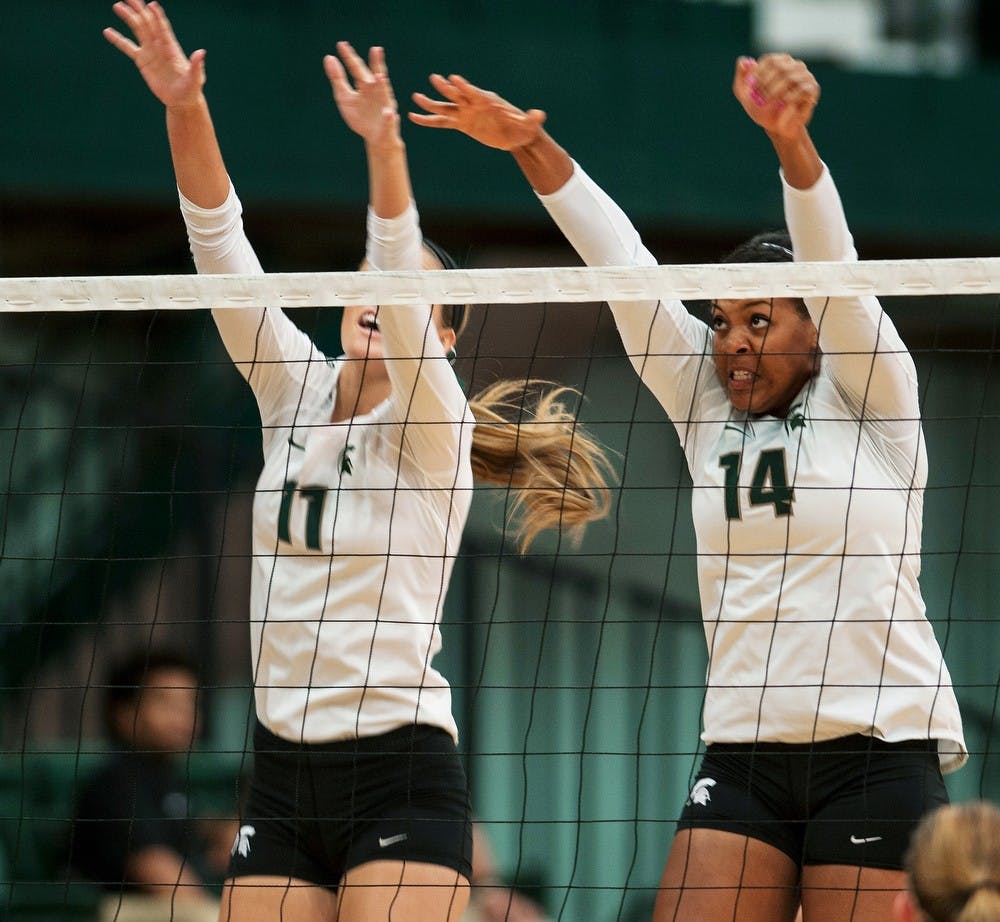 	<p>Freshman Chloe Reinig, left, and junior Jazmine White, right, block the ball against Cincinnati, Sept. 21, 2013, at Jenison Field House. <span class="caps">MSU</span> beat Cincinnati, 3-0. Margaux Forster/The State News</p>