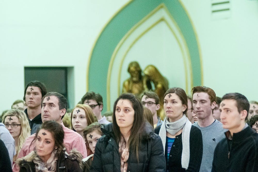 	<p>Several hundred churchgoers attend one of the five Ash Wednesday masses, Wednesday, Feb. 13, 2013, at St. John Church and Student Center, 327 M.A.C Ave. Justin Wan/The State News</p>