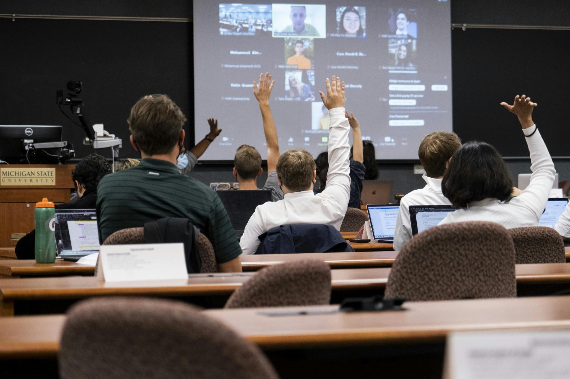 Representatives raising their hands during the presentation by the Assistant University Ombudsperson at the General Assembly meeting for ASMSU on October 7, 2021 at the International Center.