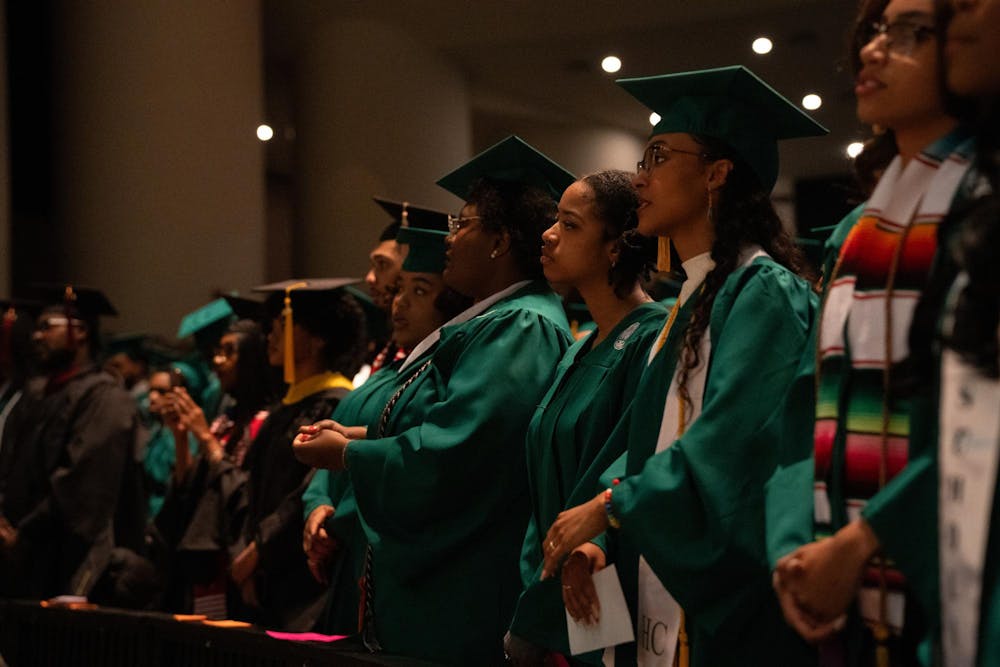 Michigan State students stand for the black national anthem during the Black Graduation ceremony at the Wharton Center on April 21, 2024.