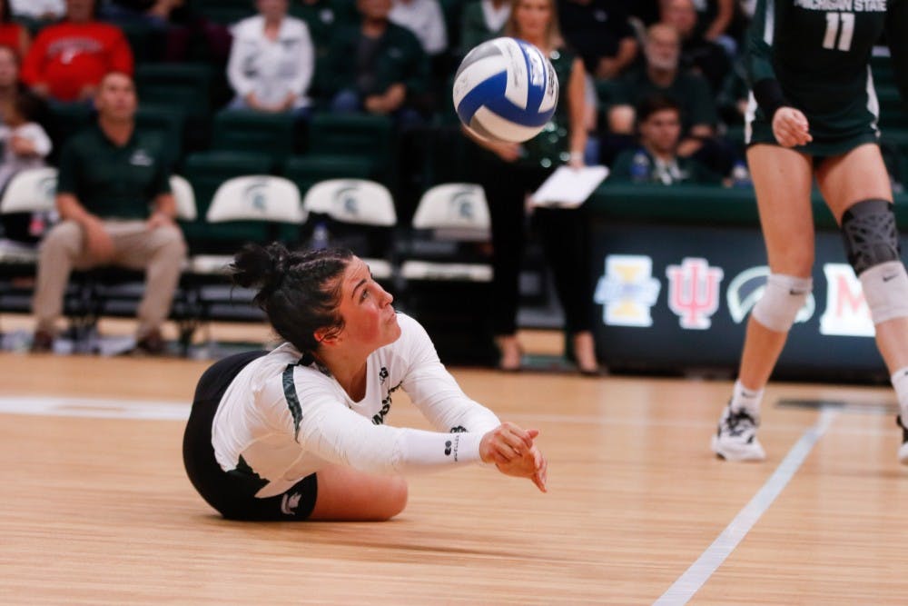 <p>Junior libero Jayme Cox (4) dives for a ball during the game against Cincinnati on Sept. 6, 2019 at Jenison Fieldhouse. The Spartans defeated the Bearcats, 3-1.</p>