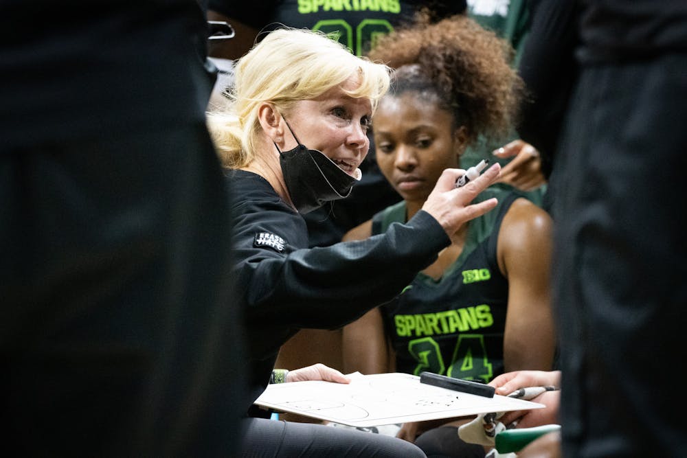 Head Coach Suzy Merchant goes over a play during a timeout of an intense fourth quarter against Penn State at the Breslin Center on Feb. 21, 2022.
