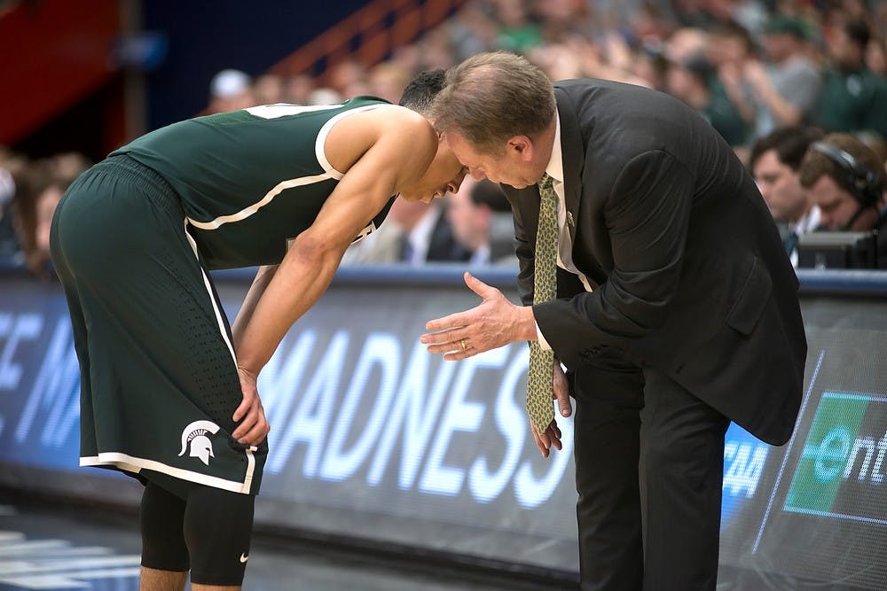<p>Senior guard Travis Trice has a moment with head coach Tom Izzo March 29, 2015, during the East Regional round of the NCAA Tournament in the Elite Eight against Louisville at the Carrier Dome in Syracuse, New York. The Spartans defeated the Cardinals in overtime, 76-70. Erin Hampton/The State News</p>