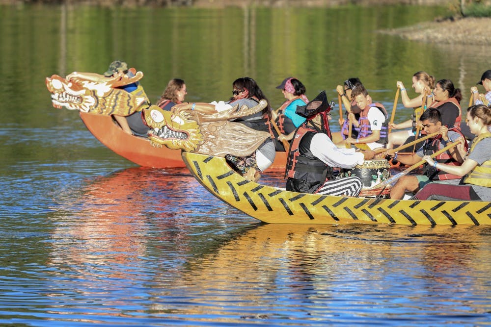 <p>The MSU College of Communication Arts and Sciences team paddles during the Dragon Boat Race at Hawk Island Park on Sept. 16, 2018.</p>