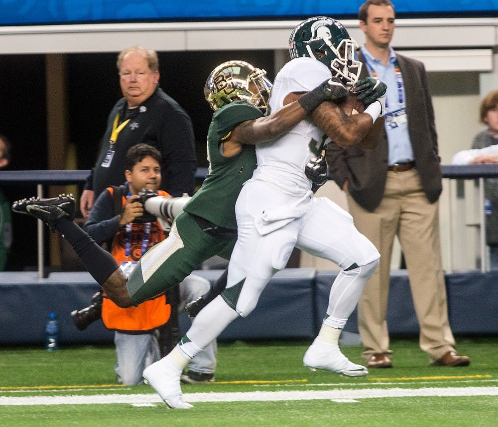 <p>Senior running back Jeremy Langford is tackled into the end zone to score a touch down Jan. 1, 2015, during The Cotton Bowl Classic football game against Baylor at AT&T Stadium in Arlington, Texas. At halftime, the Bears were leading the Spartans, 24-14. Erin Hampton/The State News</p>