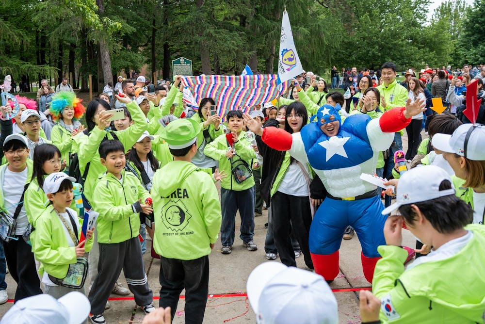 Odyssey of the Minds competitors from South Korea celebrate their team members returning from the Spontaneous part of the competition at Wells Hall in East Lansing, Michigan on May 22, 2025. Spontaneous is a secret event that challenges competitors to develop strategies that will help in a myriad of tasks, only competitors can enter the room, judges, parents, and media is not allowed. 