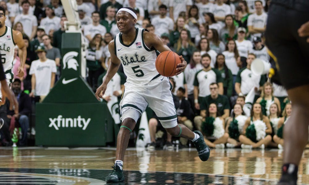Junior guard Cassius Winston (5) dribbles the ball during the game against Iowa University at Breslin Center on Dec. 3, 2018. The Spartans defeated the Hawkeyes, 90-68.