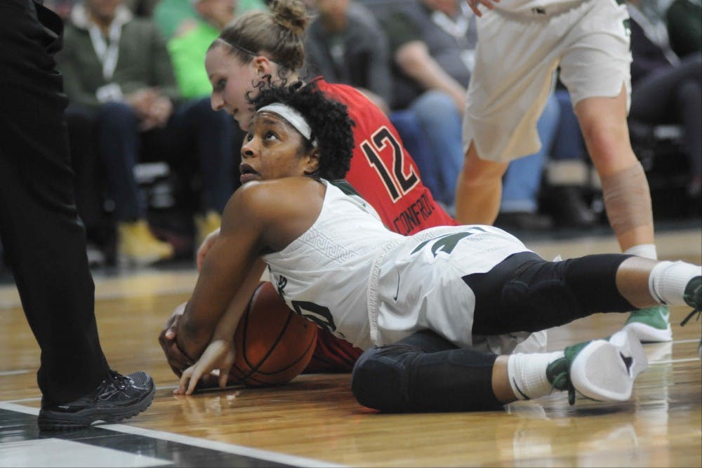 Redshirt senior guard Branndais Agee (10) dives for the ball with Maryland's senior guard Kristen Confroy (12) during the women's basketball game against Maryland on Feb. 8, 2018 at The Breslin Center. The Terrapins defeated the Spartans, 76-68. (Annie Barker | State News)