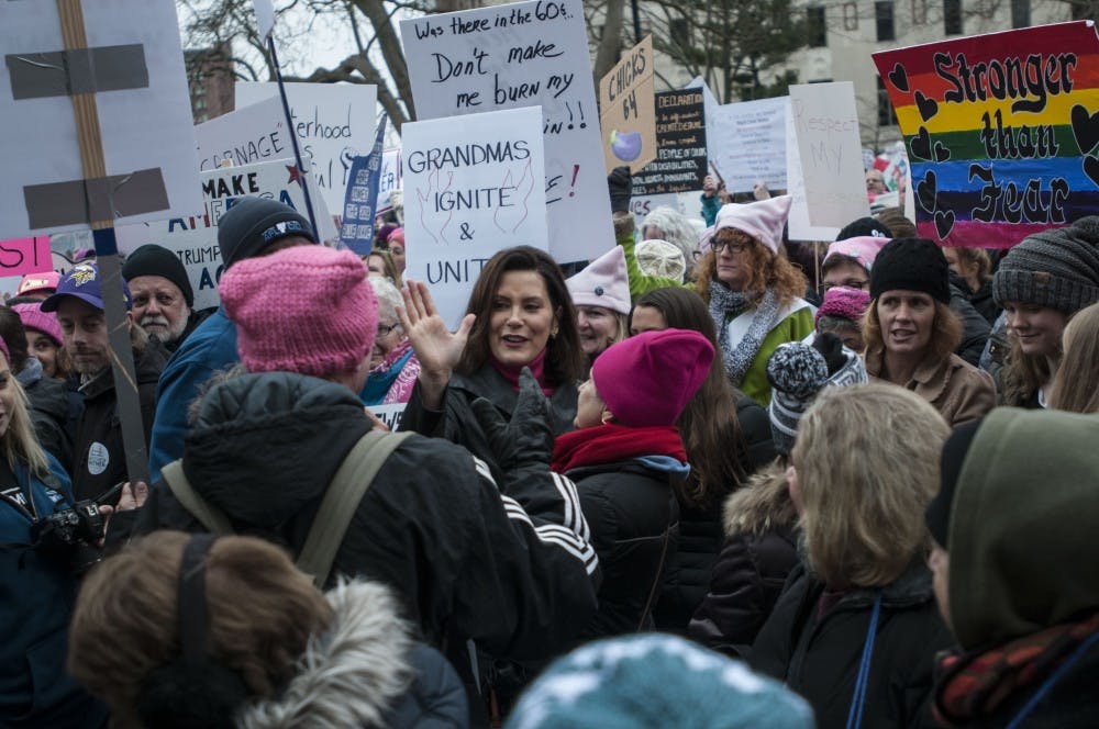 <p>Gretchen Whitmer makes her way through the crowd talking with protesters during the Women's March on Jan. 21, 2018, at Michigan State Capitol. Activists listened to speakers and rallied through peaceful protest.&nbsp;</p>
