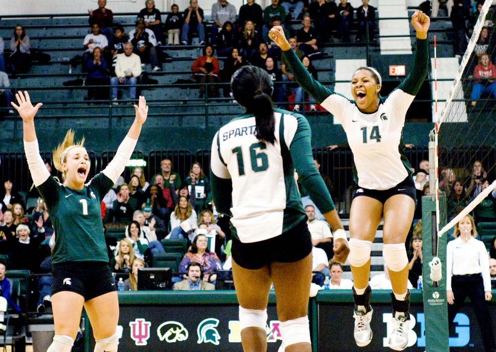 The Spartans celebrate after scoring a point against Purdue. The Spartans would eventually fall to the Boilermakers, 3-1, Saturday night at Jenison Field House. Justin Wan/The State News