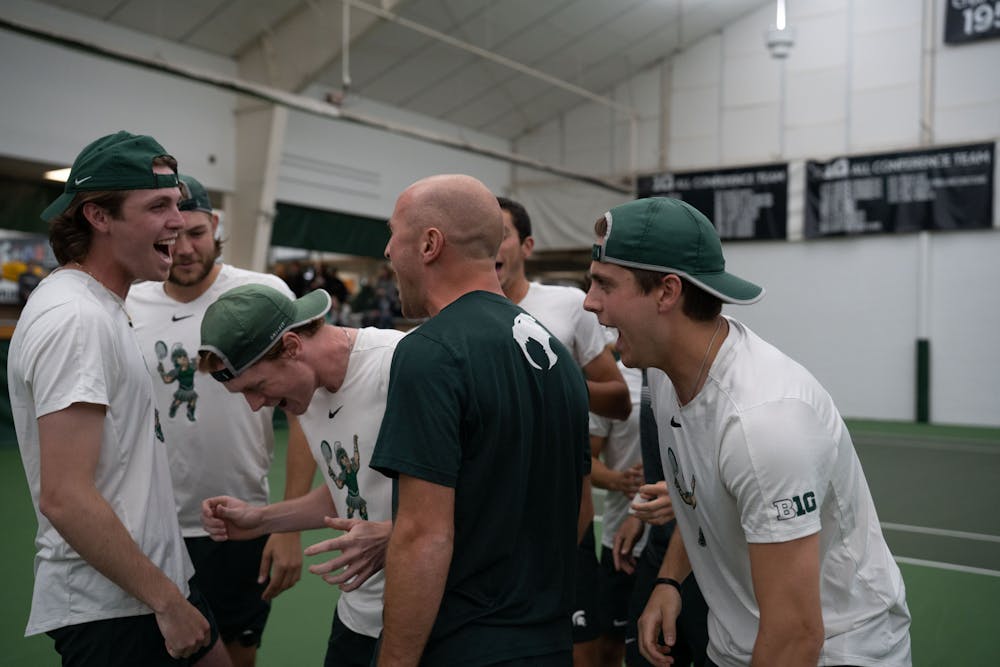 <p>The MSU men's tennis team jokes around before their match against Michigan at the MSU Tennis Center on March 30, 2023. The Spartans lost to the Wolverines 6-1.</p>
