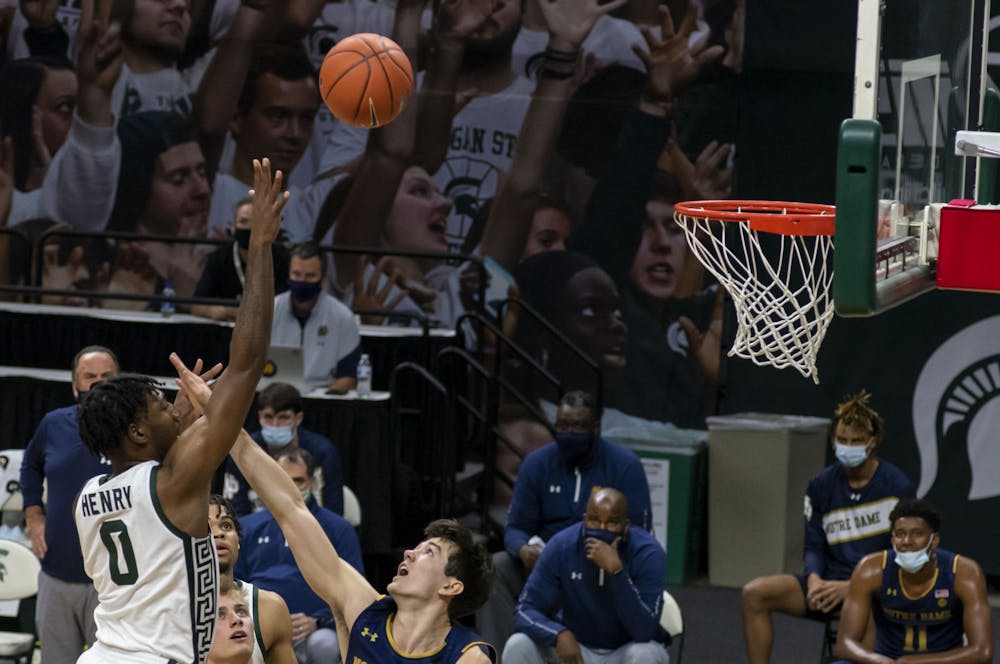 Junior forward Aaron Henry (0) scores against the Fighting Irish defense in the first half of the game. Michigan State triumphed over Notre Dame, 80-70, on Nov. 28, 2020. 