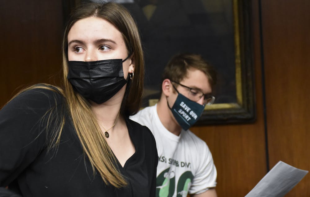 Junior freestyler Sophia Balow and junior breaststroker Travis Nitkiewicz prepare themselves for speaking in front of MSU administration at the Board of Trustees meeting on Feb 11, 2022.