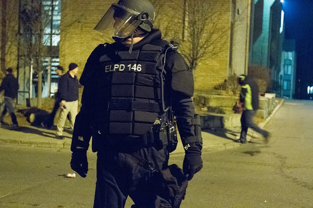 <p>East Lansing Police lock down the rioted area March 28, 2015, on Bogue Street by Cedar Village Apartments. The riot and burnings were in reaction to the men's basketball win against Oklahoma during the Eastern Regional Semi-final round of the NCAA Tournament, "Sweet 16" in Syracuse, New York. The team will move on to be a part of the Elite Eight. Staff Reports/The State News</p>