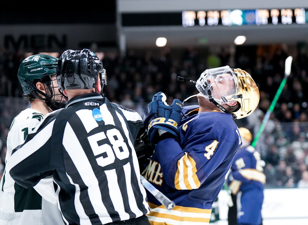 <p>Michigan State's junior forward Jeremy Davidson (11) and Notre Dame's graduate student defender Nick Leivermann (4) fight during a game against Notre Dame at Munn Ice Arena on Feb. 3, 2023. The Spartans defeated the Fighting Irish 3-0.</p>