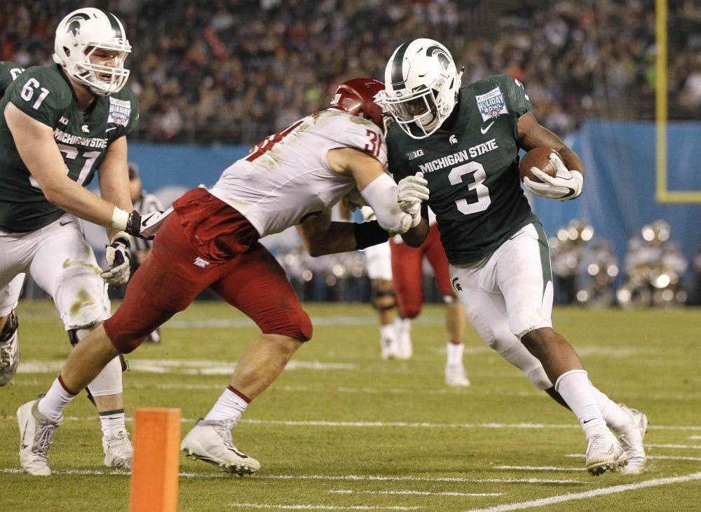 <p>Washington State's Issac Dotson pushes Michigan State's LJ Scott (3) just shy of the goal line during the second quarter in the Holiday Bowl at SDCCU Stadium in San Diego on Thursday, Dec. 28, 2017. (Hayne Palmour IV/San Diego Union-Tribune/Tribune News Service)</p>