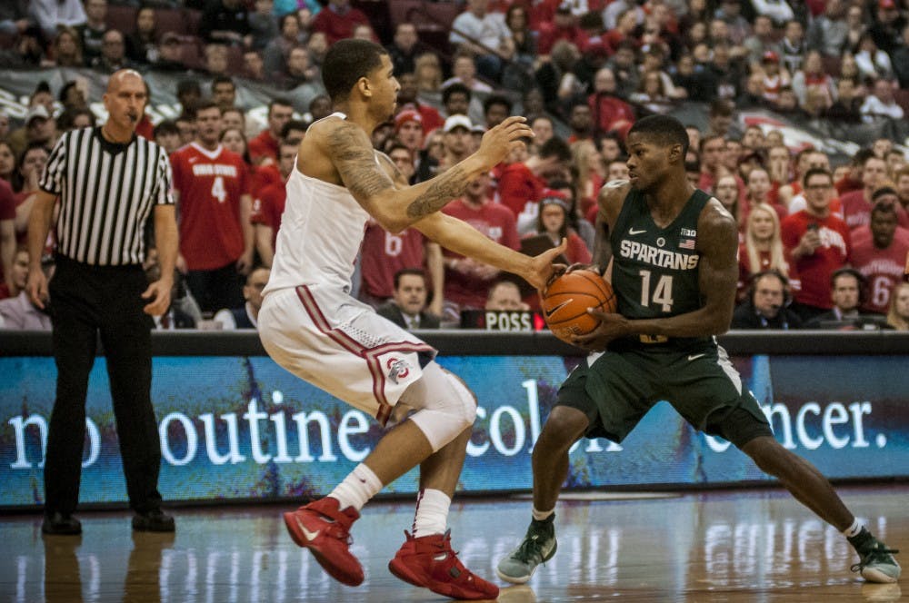 Senior guard Eron Harris (14) looks to drive past Ohio State forward Marc Loving (2) during the game against Ohio State on Jan. 15, 2017 at the Jerome Schottenstein Center. The Spartans were defeated by the Buckeyes, 67-72.