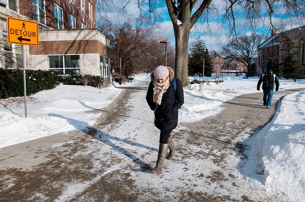 	<p>Engineering senior Claire Veit walks, bundled up against the cold, Jan 28, 2014, outside Agriculture Hall. Temperatures remained around ten degrees below zero throughout the day according to the National Weather Service. Casey Hull/The State News</p>