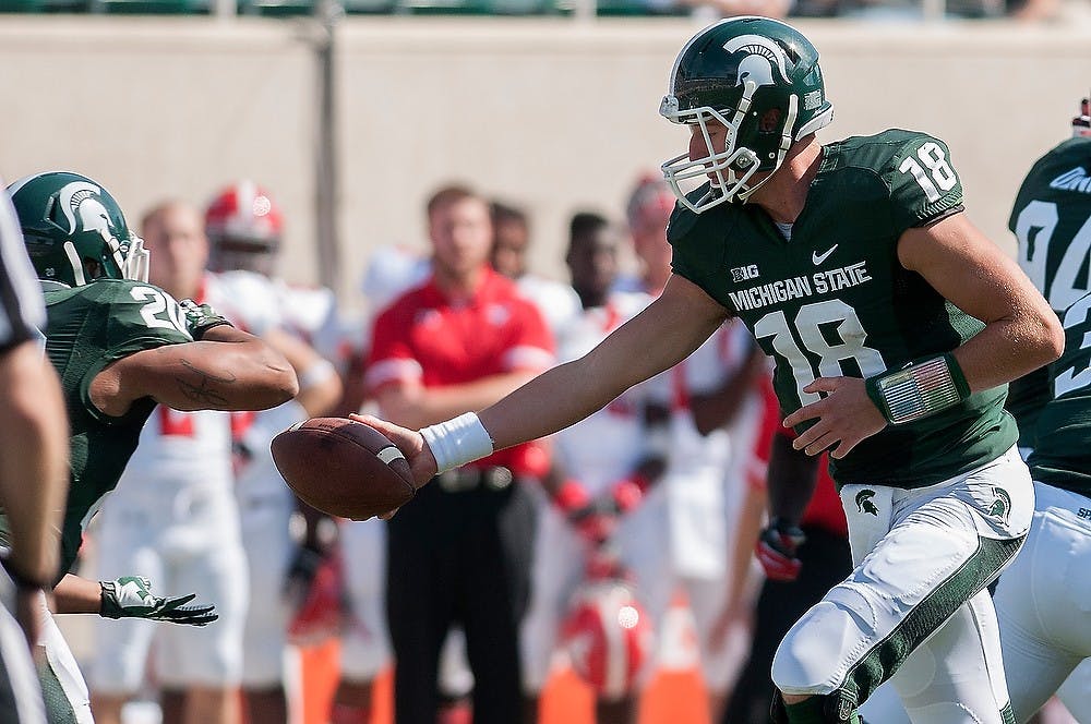 	<p>Sophomore quarterback Connor Cook hands off the ball to junior running back Nick Hill on Sept. 14, 2013, at Spartan Stadium. The Spartans defeated Youngstown State, 55-17. Julia Nagy/The State News</p>