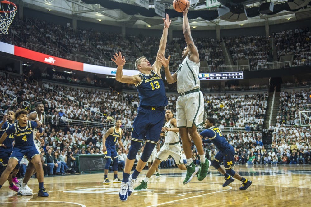 Sophomore forward Nick Ward (44) shoots as he is covered by Michigan forward Moritz Wagner (13) during the first half of the men's basketball game against Michigan on Jan. 13, 2018 at Breslin Center. The Spartan's led the first half, 37-34. (Nic Antaya | The State News)