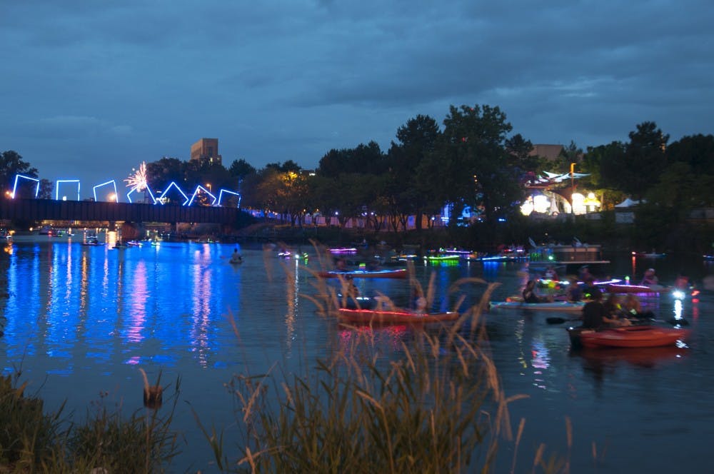 Illuminated boats on July 4, 2016 on the Grand River. Boaters were waiting along Adabo Riverfront Park for the City of Lansing's fireworks to start, some launched fireworks from their boats.