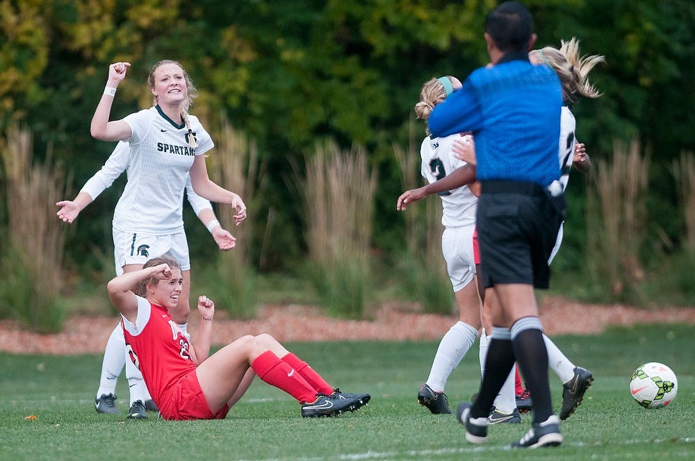 <p>Sophomore defender Jessica Kjellstrom and Ohio State defender Nicole Hopkins react to a penalty call on Oct. 16, 2014, at the DeMartin Soccer Stadium at Old College Field. The Spartans defeated the Buckeyes, 2-1. Jessalyn Tamez/The State News </p>