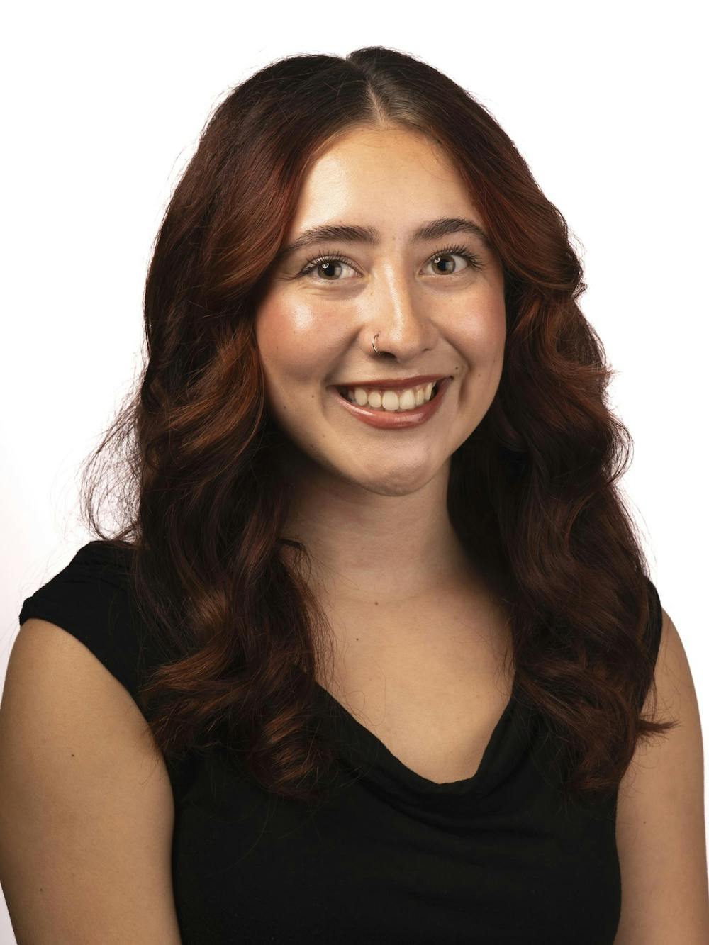 A staff member poses for a headshot at The State News office on Thursday, Sept. 3, 2026, in East Lansing, Michigan.