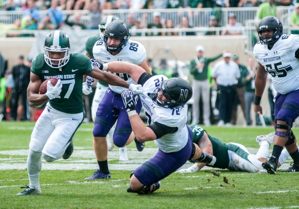 <p>Khari Willis (27) advances the ball after an interception during the game against Northwestern on Oct. 6, 2018 at Spartan Stadium. </p>