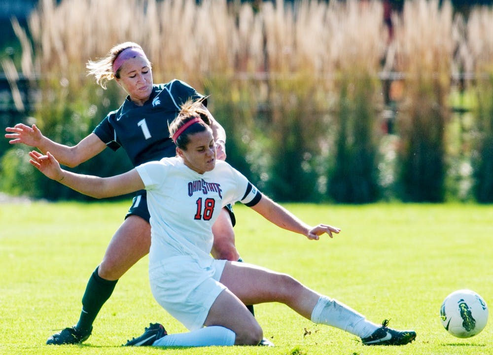 Ohio State forward Lauren Granberg slide tackles the ball away from senior defenseman Katelin Chaklos. The Spartans defeated Ohio State, 2-0, in their final home game on Sunday afternoon at DeMartin Stadium at Old College Field. 