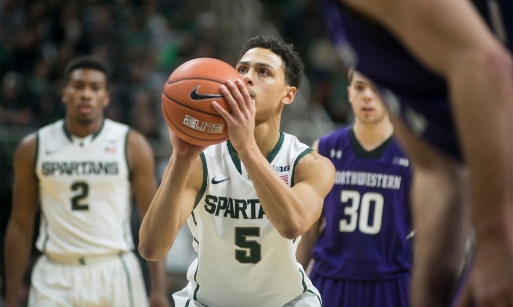 Junior guard Bryn Forbes aims o make a free-throw Jan. 11, 2015, during the game against Northwestern at Breslin Center. At halftime, the Spartans were tied with the Wildcats, 40-40. Erin Hampton/The State News