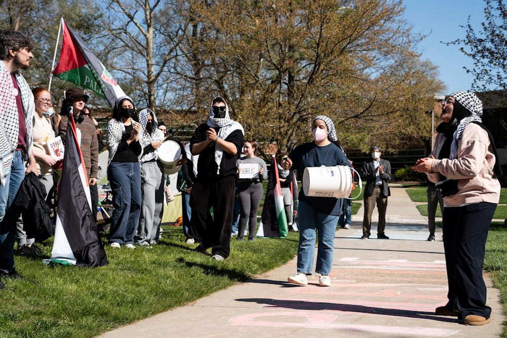 Michigan State University students and community members yell chants at the Gaza solidarity encampment in People’s Park on MSU’s campus on April 25, 2024.