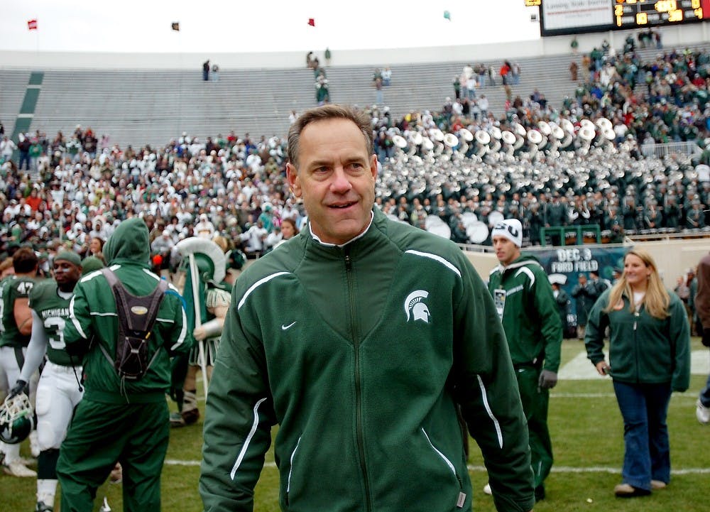 <p>Coach Mark Dantonio smiles as he walks off the field while his team celebrates after defeating Purdue on Nov. 8, 2008, at Spartan Stadium.  Sam Ruiz/The State News</p>