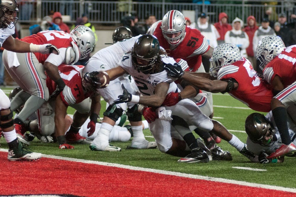 Sophomore running back Gerald Holmes makes the Spartan's second touchdown of the night during the fourth quarter of the football game against Ohio State on Nov. 21, 2015 at Ohio Stadium in Columbus, Ohio. The Spartans defeated the Buckeyes, 17-14.