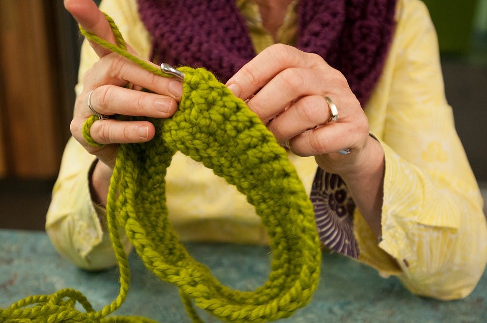 <p>Director of RISE and alumna Laurie Thorp demonstrates a crochet scarf to the rest of the class Oct. 3, 2014, in Bailey Hall. Dylan Vowell/The State News</p>