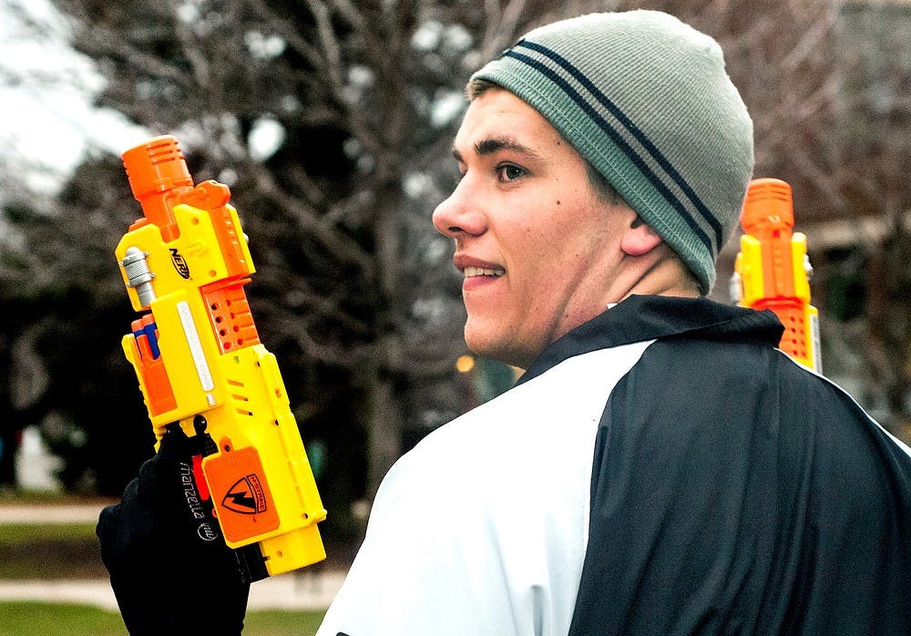 	<p>Electrical engineering sophomore Nick Takala keeps his Nerf blasters at the ready April 10, 2013 while walking down Farm Lane. This is the fourth-major game of Spartans Vs. Zombies that has been played on campus. </p>