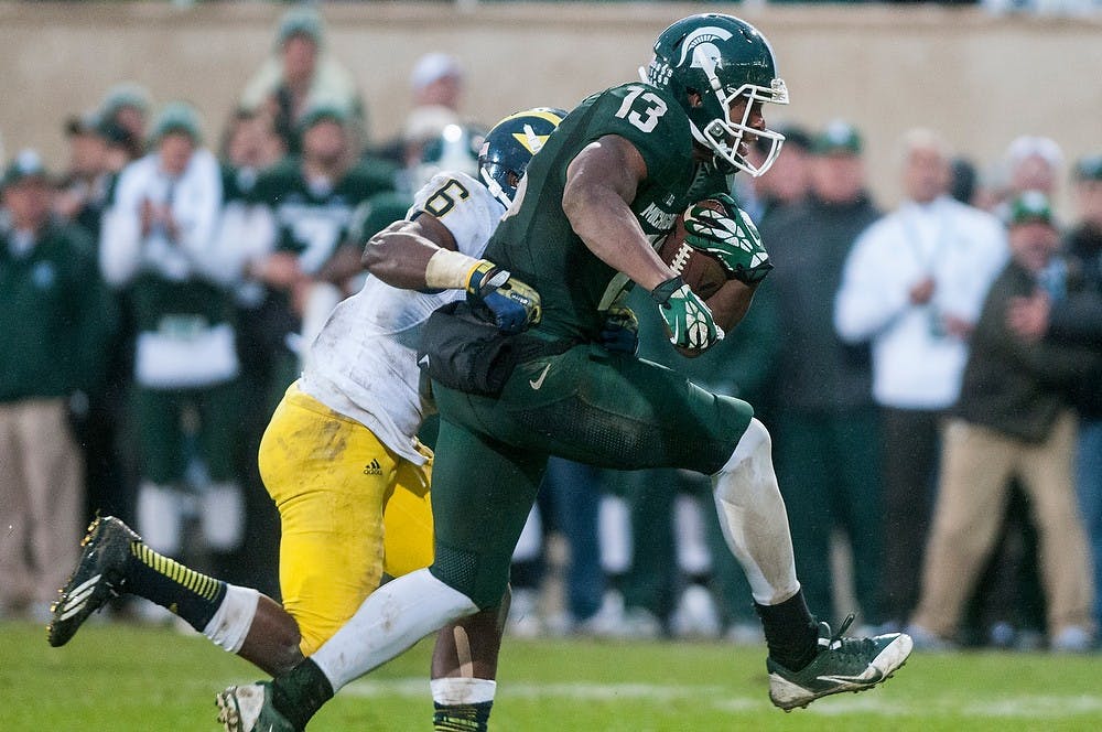 	<p>Senior wide receiver Bennie Fowler gets wrapped up by Michigan defensive back Raymon Taylor during the game against Michigan on Nov. 2, 2013, at Spartan Stadium. The Spartans defeated the Wolverines, 29-6. Khoa Nguyen/The State News</p>