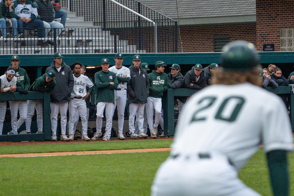Michigan State players talk and look onto the field in the dugout between innings during Michigan State’s game against Michigan at Jeff Ishbia Field at McLane Stadium in East Lansing, Mich., on Friday, April 10, 2026.