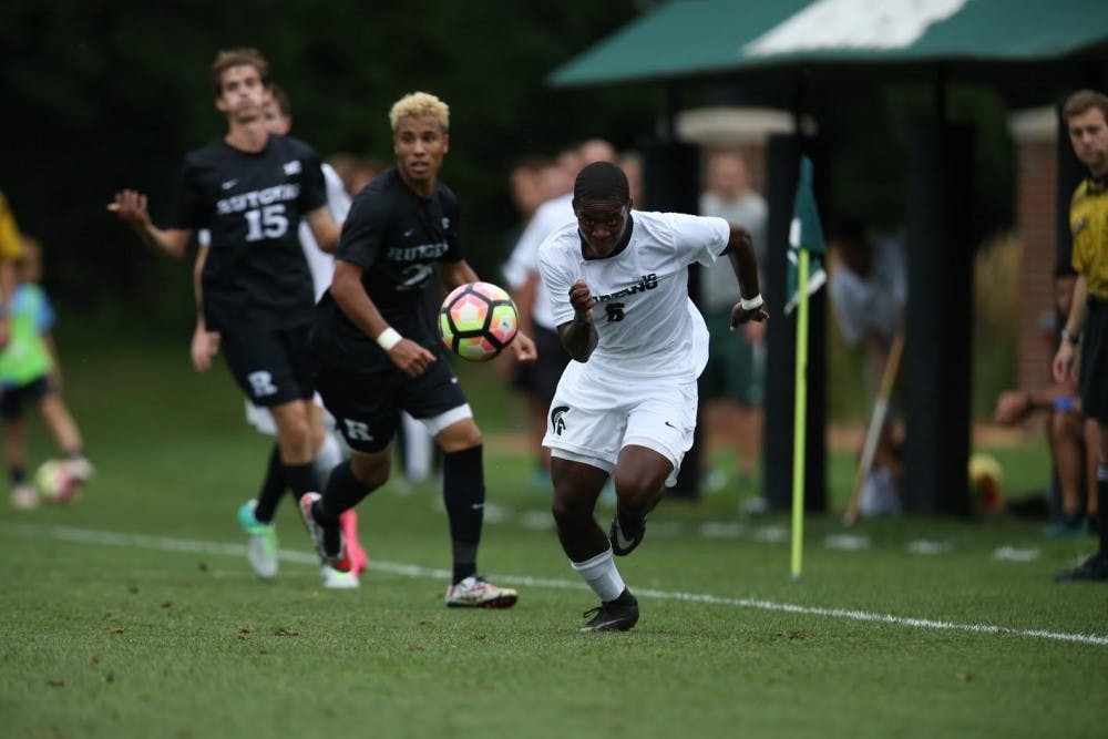 <p>Sophomore forward DeJuan Jones kicks a ball past Rutgers defenders on Sept. 9. &nbsp;MSU defeated the Scarlet Knights 4-0. &nbsp;Photo courtesy of Rey Del Rio.</p>