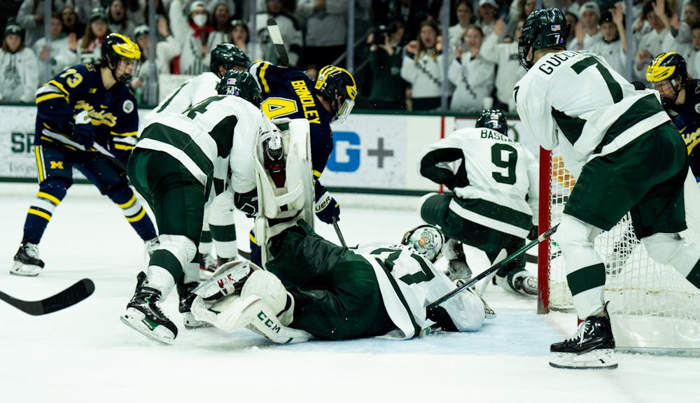 Graduate student goalkeeper Dylan St. Cyr (37) makes a save during a game against the University of Michigan at Munn Ice Arena on Dec. 9, 2022. The Spartans defeated the Wolverines 2-1. 
