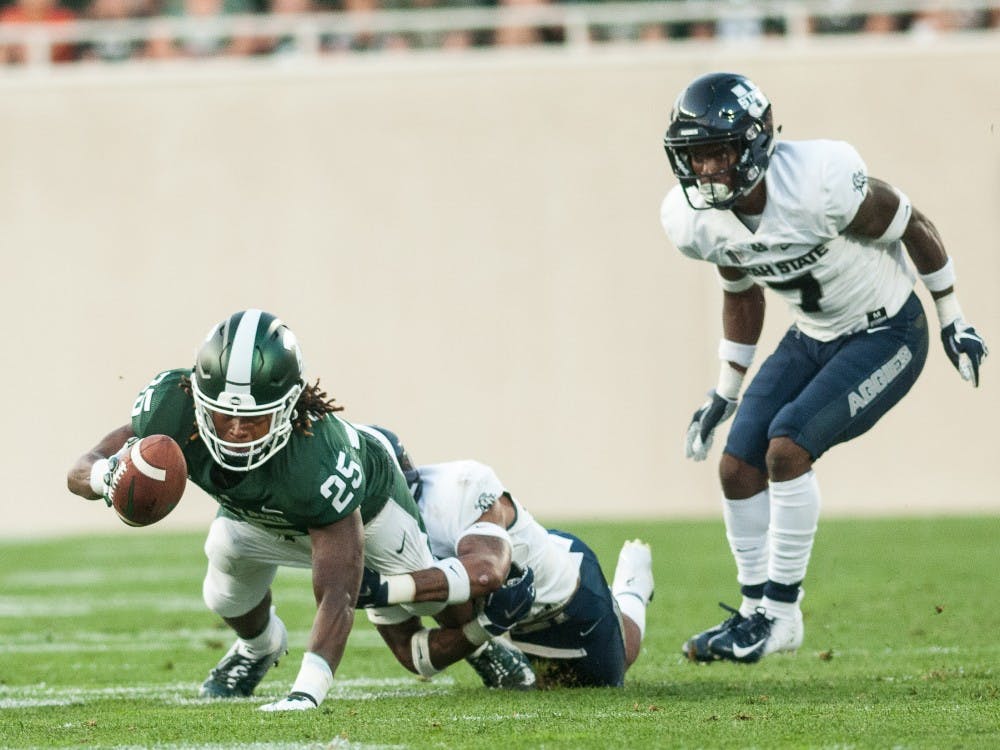 Junior wide receiver Darrell Stewart Jr. (25)  stretches the ball out for a first down during the game against Utah State on Aug. 31, 2018 at Spartan Stadium. The Spartans defeated the Aggies 38-31.