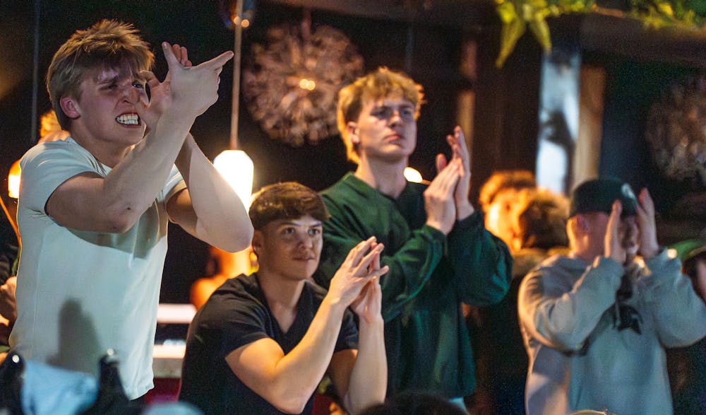 <p>Fans cheer as Michigan State scores against UConn during the NCAA men’s basketball tournament regional semifinal while watching at Harper’s Brew Pub in East Lansing, Michigan on Friday, March 27, 2026.</p>